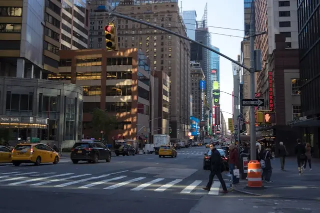Pedestrians and cyclists crossing a New York City crosswalk NYC Traffic Accidents Fall 2025.