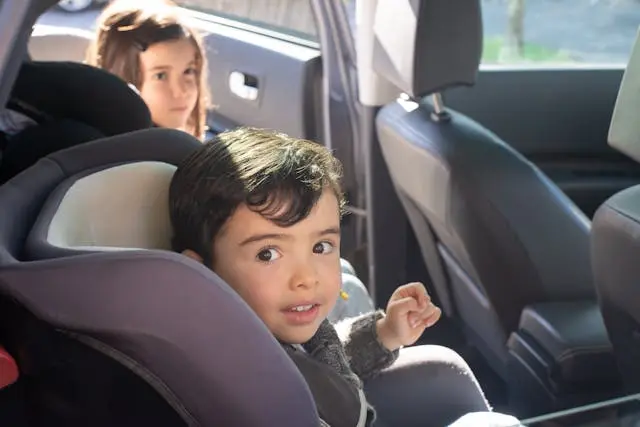 Child safely secured in a car seat with sibling in the backseat during Child Passenger Safety Awareness Week 2025.