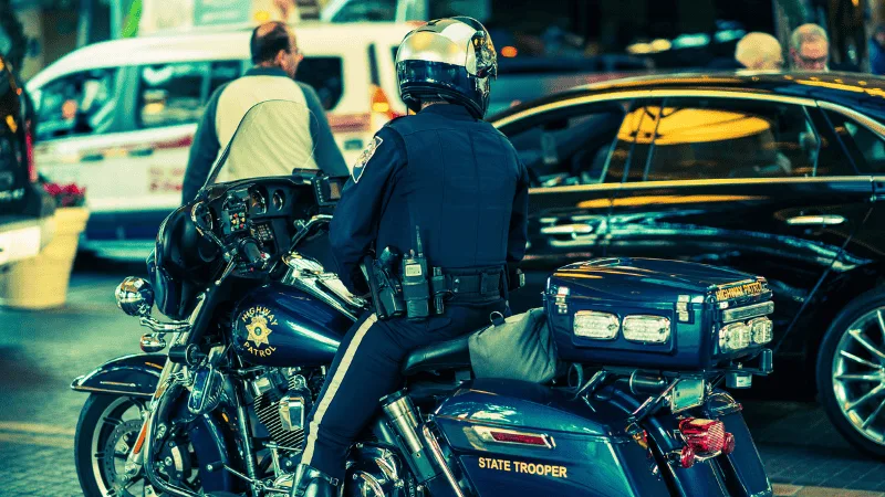 State Trooper on top of his motorcycle posing for a photo