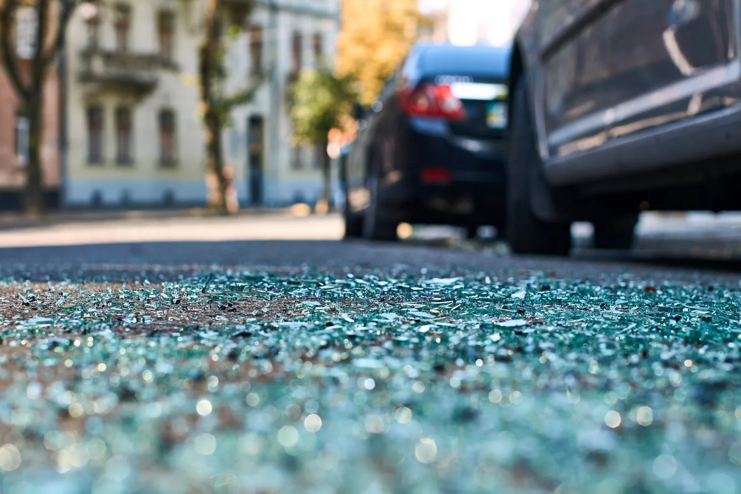 Sharp shards of car glass on the asphalt