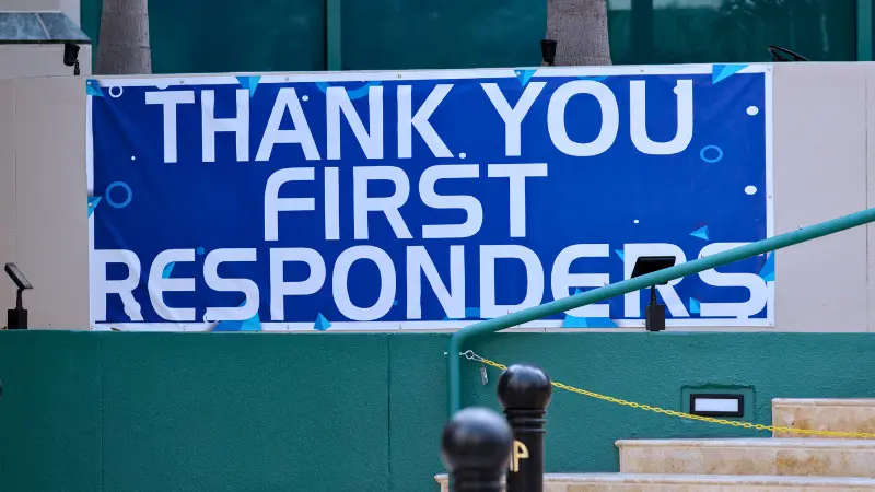 Blue banner thanking first responders with "Thank You First Responders" text displayed outside a building
