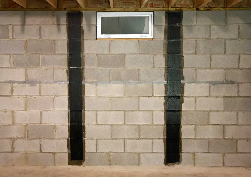 Carbon fiber straps reinforcing a bowing basement wall in a New Jersey home