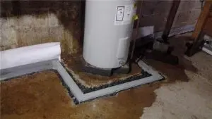 Basement drainage system with a sump pump and water heater, showcasing effective water management for basement waterproofing.