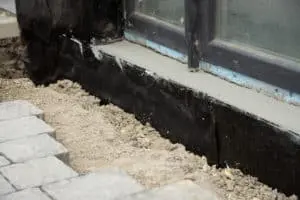 basement and foundations repair by insulating the basement concrete wall.