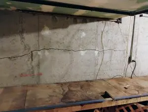 Horizontal crack in basement wall showing bowing foundation damage caused by hydrostatic pressure