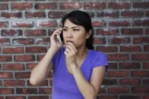 Women standing in front of wall calling for help.
