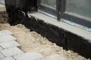 basement and foundations repair by insulating the basement concrete wall.