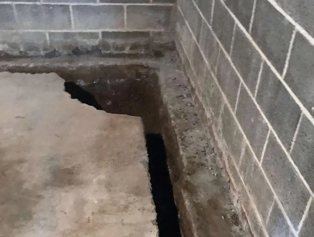 Home Protection Starts Here: Basement Waterproofing Tips Basement trench with exposed foundation and concrete slab, illustrating waterproofing preparation for moisture control and structural integrity.