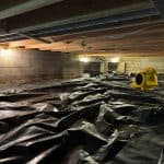 Crawl space with vapor barrier installation to prevent moisture damage and protect floor structure in an Indiana home
