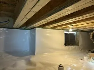 Completed crawl space encapsulation in Indianapolis, IN featuring a sealed white vapor barrier, insulated foundation walls, and a clean, moisture-controlled crawl space.