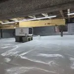 Encapsulated crawl space with a white vapor barrier and Santa Fe dehumidifier installed beneath a home.