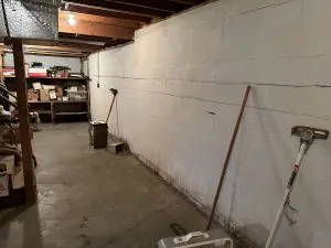Interior view of a concrete block basement foundation wall in need of structural inspection in Indianapolis.