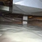 Encapsulated crawl space in Bloomington, IN with sealed white vapor barrier installed across the floor and support columns for moisture protection.
