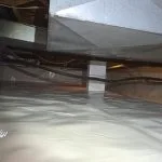 Encapsulated crawl space in Bloomington, IN with sealed white vapor barrier installed across the floor and support columns for moisture protection.