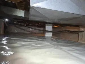 Encapsulated crawl space in Bloomington, IN with sealed white vapor barrier installed across the floor and support columns for moisture protection.