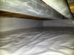 A clean, well-lit crawl space with smooth white plastic sheeting covering the ground and walls. Exposed wooden beams and ductwork visible above.