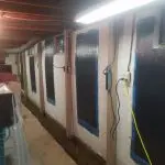 Basement wall with carbon fiber reinforcement and electrical wiring, showcasing foundation repair methods for structural integrity.