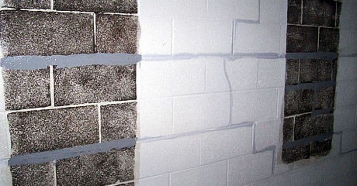 Foundation wall with visible crack repairs and sealant application, illustrating foundation stabilization techniques relevant to professional repair services.
