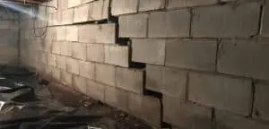 Cracked foundation wall showing significant separation between concrete blocks, illustrating potential structural issues and the need for foundation repair methods.