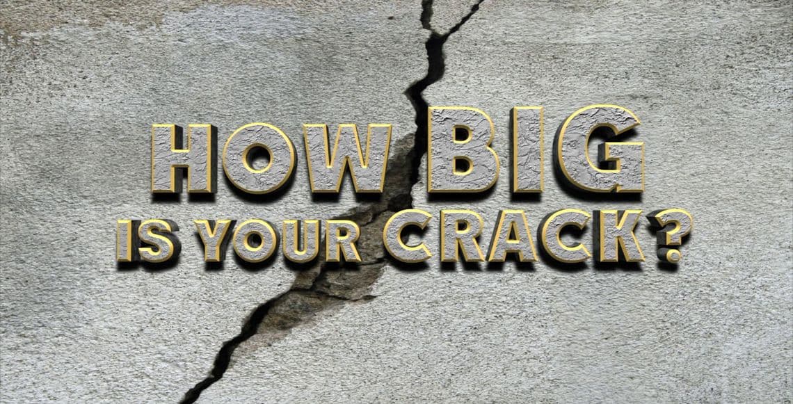 Text overlay on cracked concrete wall asking, "How big is your crack?quot; related to structural issues in residential and commercial settings.