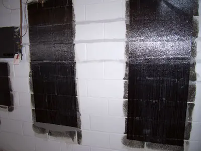 Carbon fiber sheets applied to concrete wall for structural reinforcement and repair, showcasing a durable solution for wall restoration.