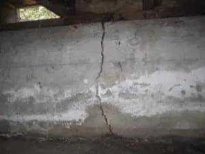 Vertical foundation crack repair example showing a long crack in a concrete basement wall caused by structural movement and soil pressure.