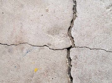 Cracked concrete surface illustrating potential foundation issues, relevant to carbon fiber reinforcement solutions for structural integrity.