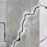 Close-up of foundation cracks in concrete, illustrating various types and severity, highlighting the importance of immediate repair to prevent structural damage and water infiltration.