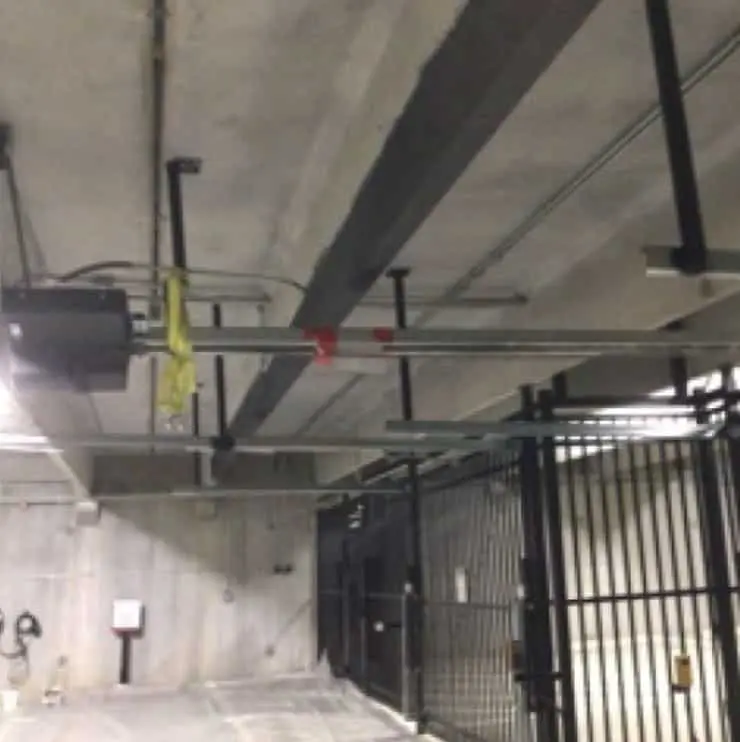 Interior view of a parking garage with structural elements, showcasing StablWall's carbon fiber reinforcement system for infrastructure applications.