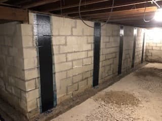 Foundation walls reinforced with carbon fiber straps to prevent bowing and shearing, showcasing a basement repair solution by StablWall.