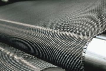 Close-up of StablWall carbon fiber fabric roll, showcasing its texture and strength for wall reinforcement in construction.