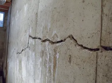 Cracked basement wall indicating potential foundation issues, relevant to foundation repair discussions.
