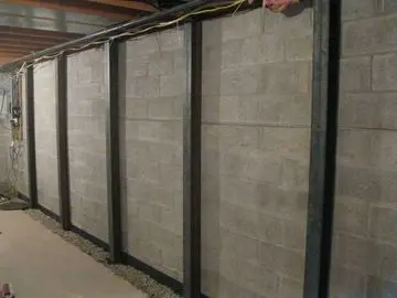 Carbon fiber strips installed on foundation walls for reinforcement, showcasing a structural repair solution for bowed basement walls.