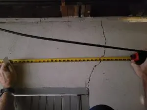 Foundation wall crack being measured during a basement inspection in Southwest Virginia