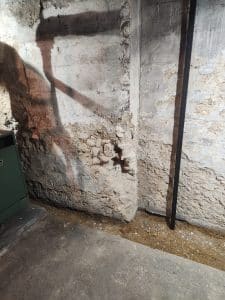 Foundation repair needed for deteriorating basement wall with moisture damage
