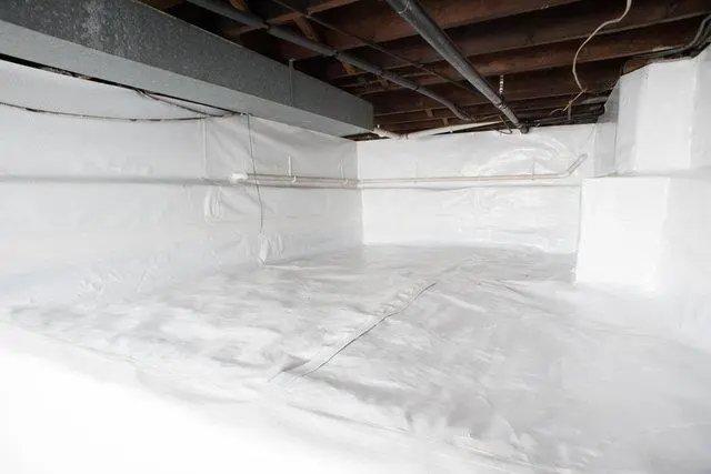 Professional crawl space encapsulation cost project showing a sealed crawl space with a heavy-duty white vapor barrier covering the floor and foundation walls.