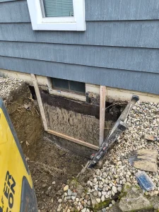 Foundation excavation for basement egress window installation in Perrysburg, Ohio