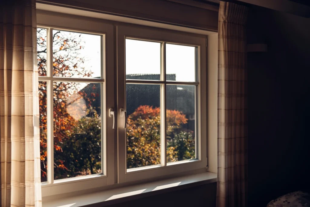 Energy-efficient replacement window in a New Jersey home with autumn foliage visible outside