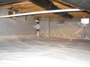 A clean, well-lit crawl space with a white vapor barrier on the floor and walls. Insulated pipes run across the ceiling, conveying a sense of orderliness.