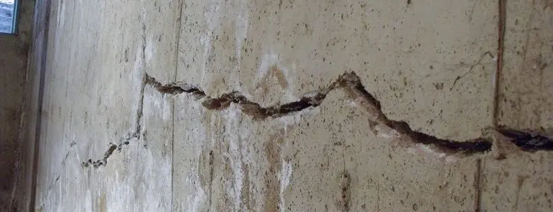 Horizontal foundation wall crack caused by hydrostatic pressure effects on foundation damage in a basement.