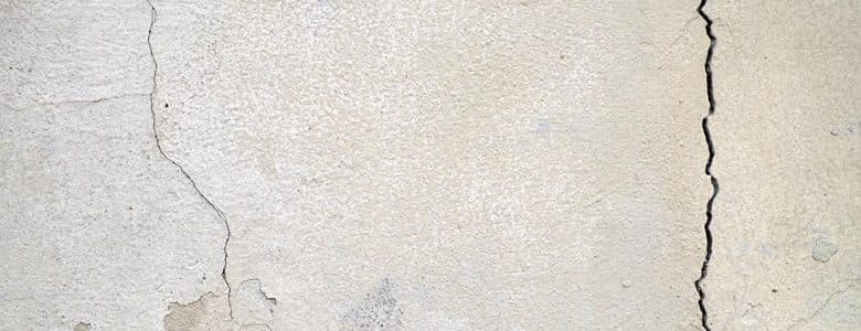 Large vertical foundation crack in a concrete wall indicating potential structural movement and foundation damage