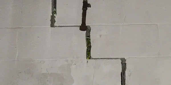 Stair-step foundation cracks in a concrete block basement wall