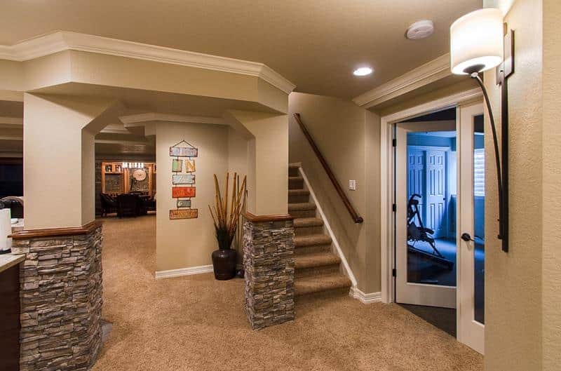 A fully carpeted and finished basement in a large house