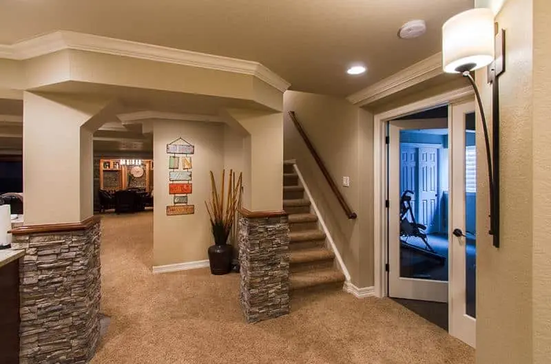 A fully carpeted and finished basement in a large house