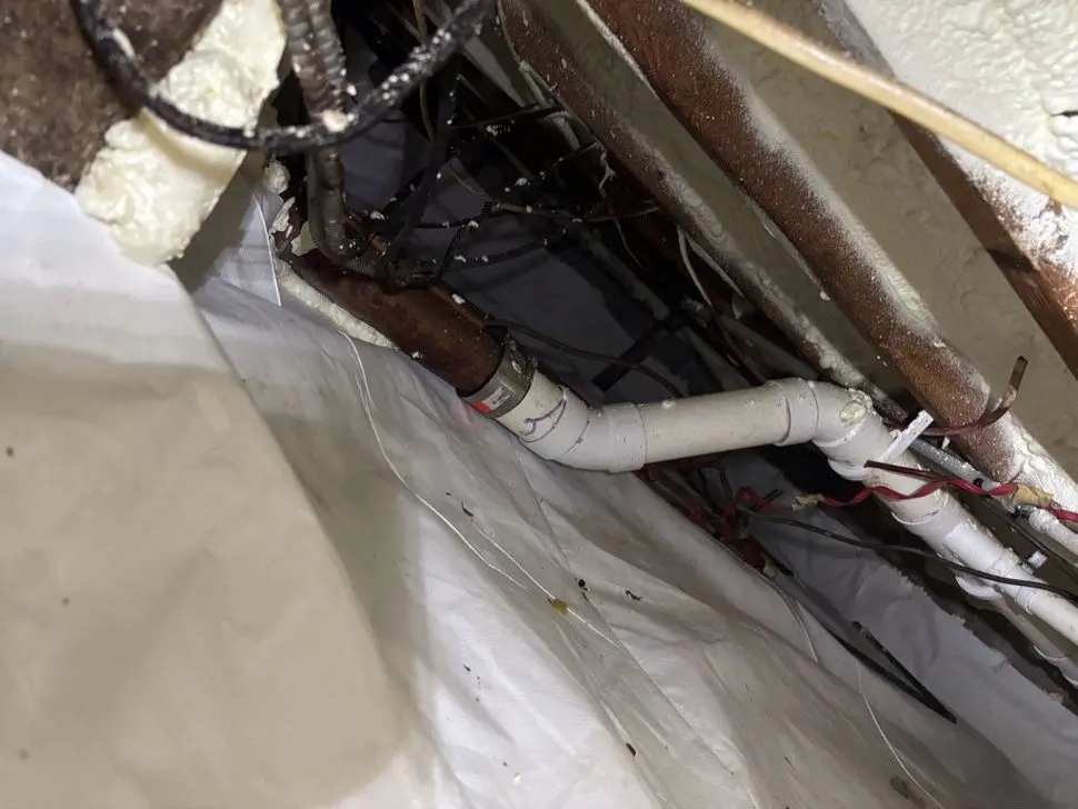 Crawl space encapsulation in CT with sealed vapor barrier around plumbing and floor framing