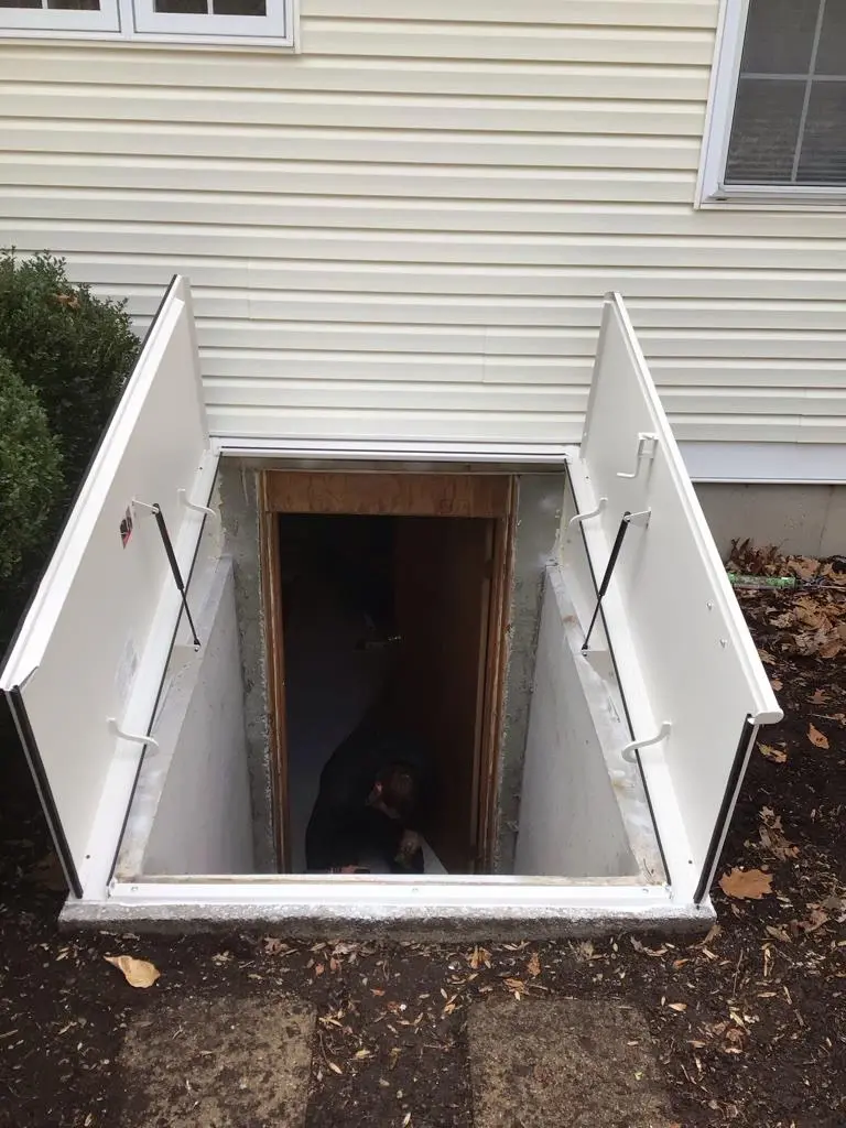 Roofers completing the roofing installation process on a New Jersey home with dark roof tiles