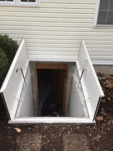 Roofers completing the roofing installation process on a New Jersey home with dark roof tiles