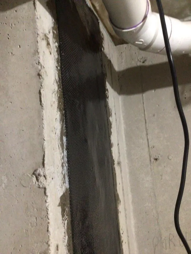 Completed carbon fiber foundation crack repair reinforcing a basement wall in Niantic, CT.