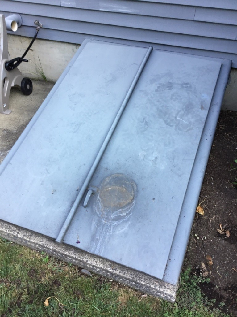 Old rusted and warped basement hatchway door in Milford CT before Bilco door replacement