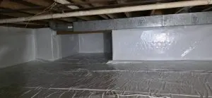 Encapsulated crawl space with vapor barrier installed for moisture control and mold prevention